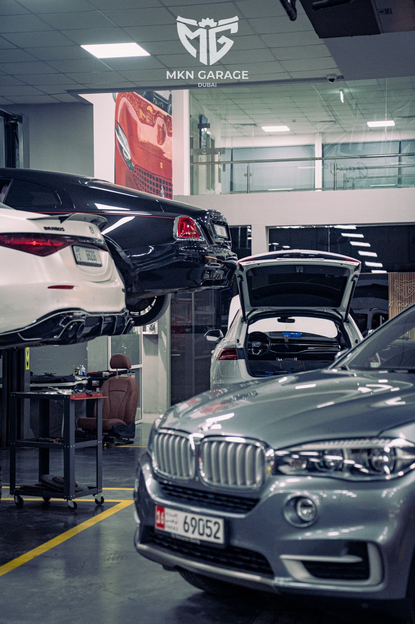 BMW X5 with its bonnet open in the MKN workshop