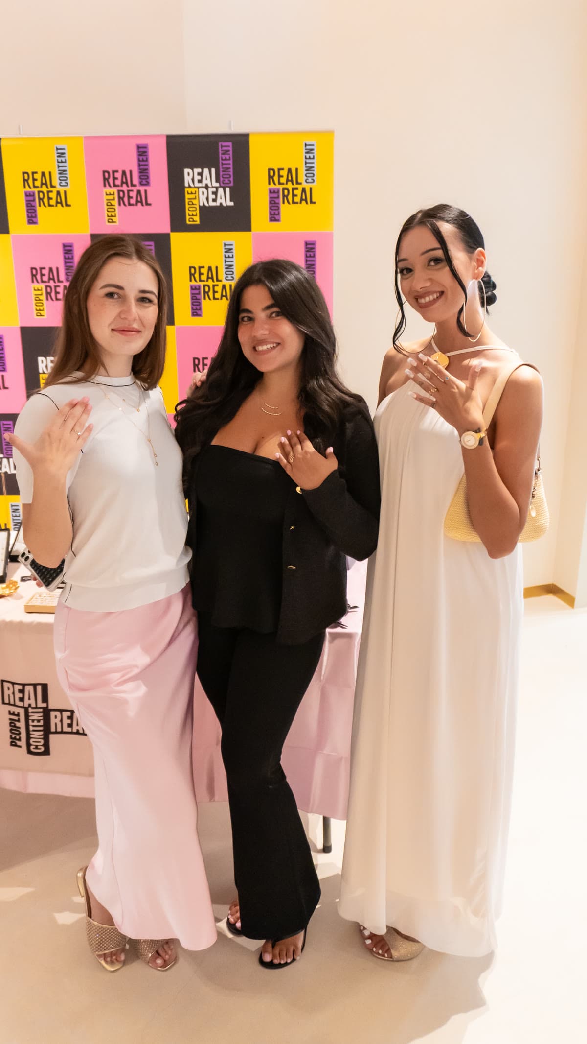 Guests posing at the event backdrop