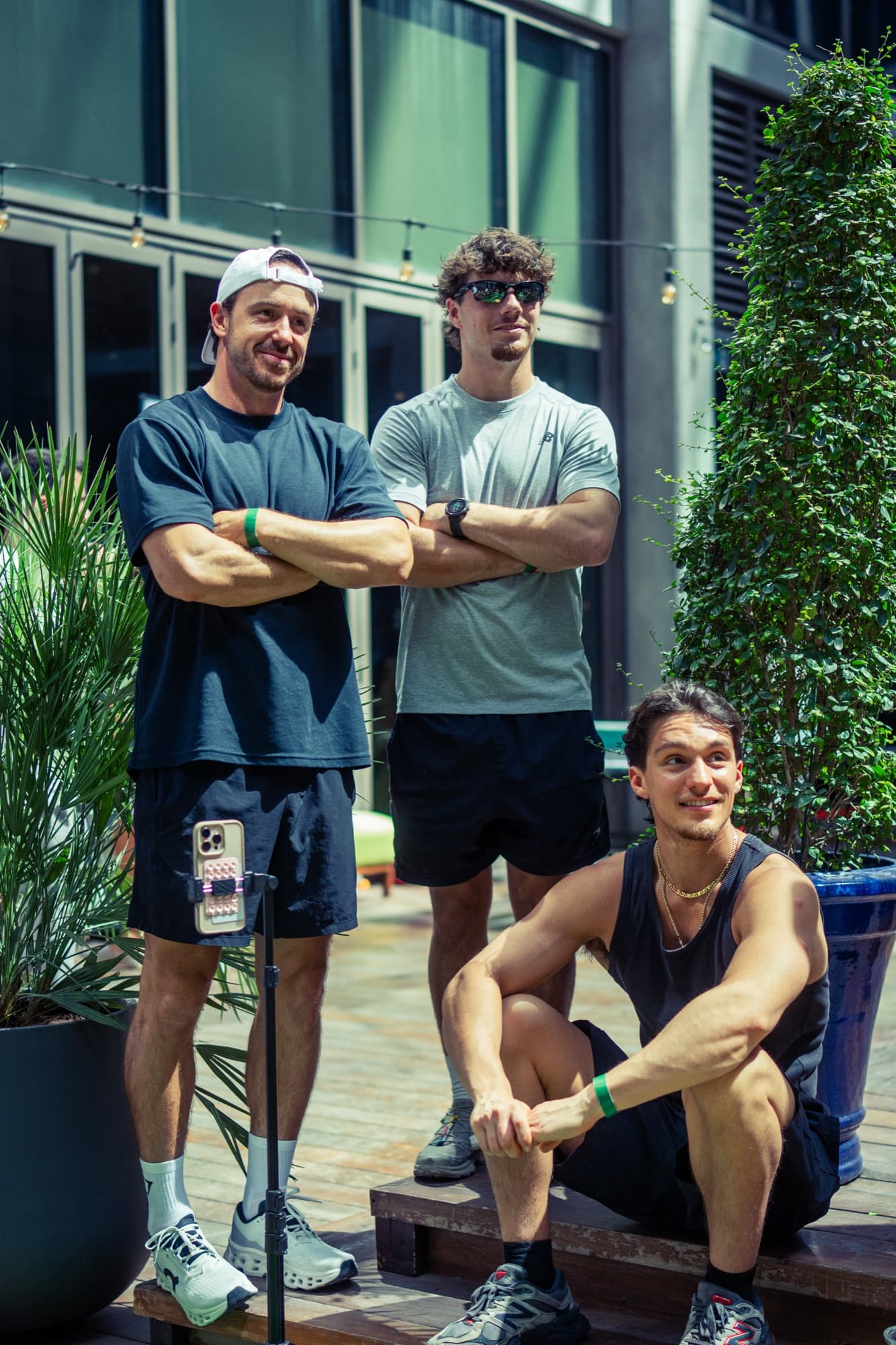 Three men posing together at an outdoor Clubhouse event