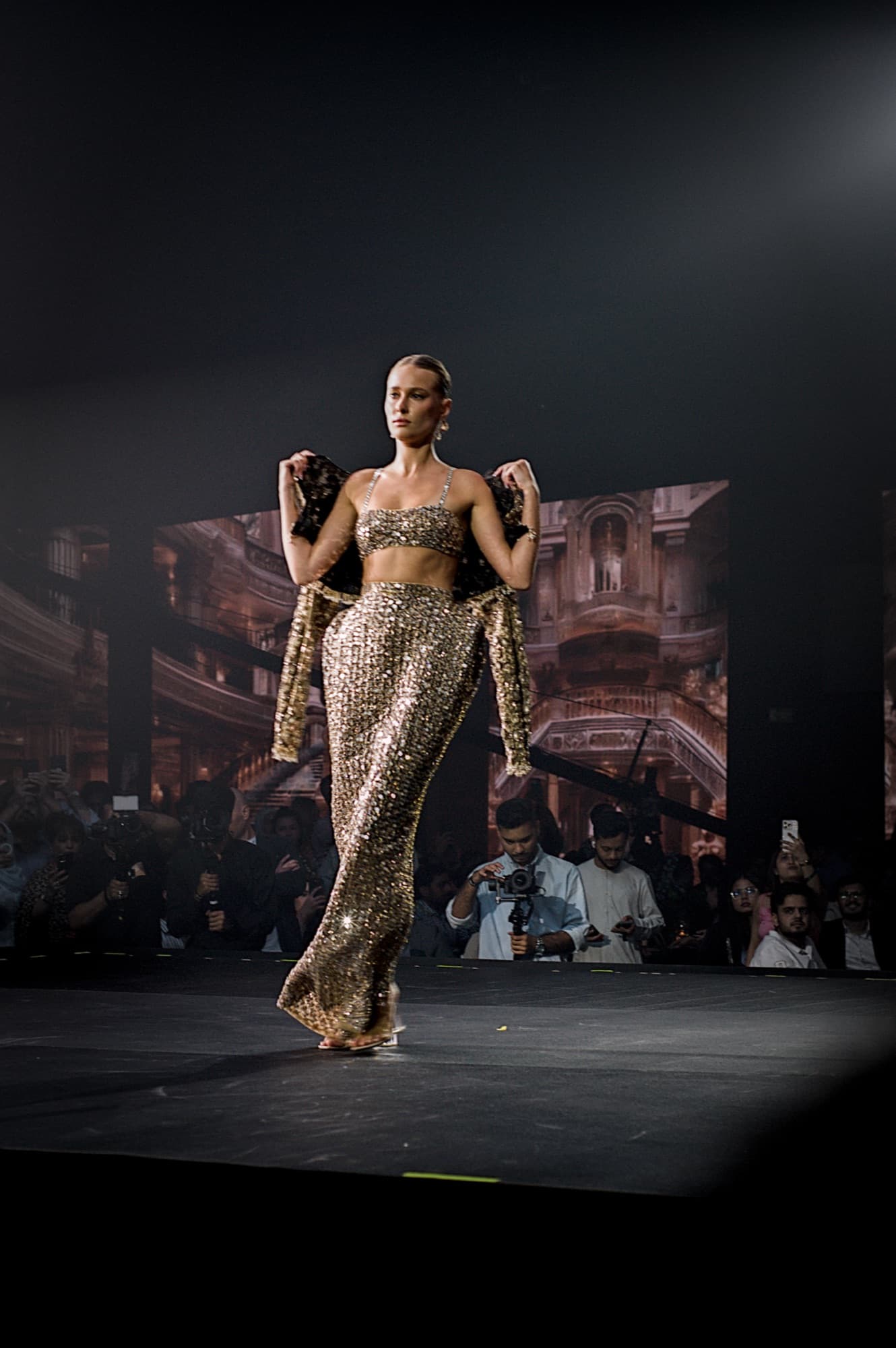 Model in an embellished gown on the Elle Residence runway