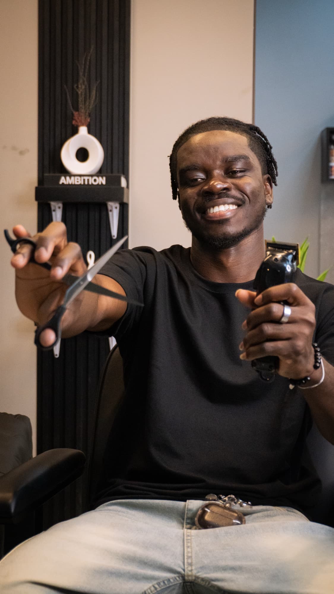 Barber smiling with a trimmer at Epic Luxe