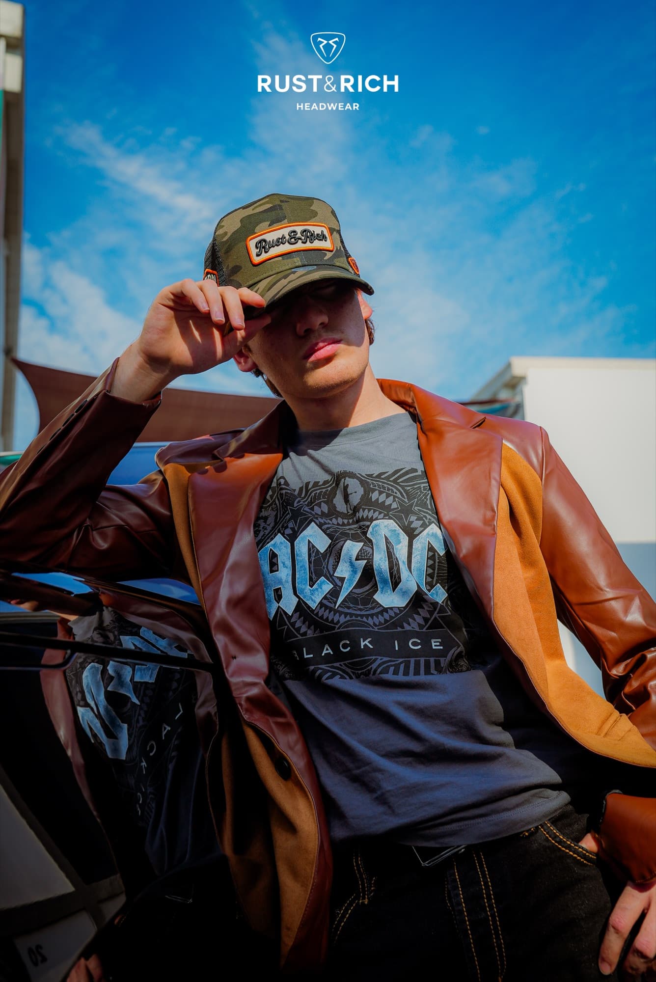 Rust and Rich campaign look in a leather jacket and cap